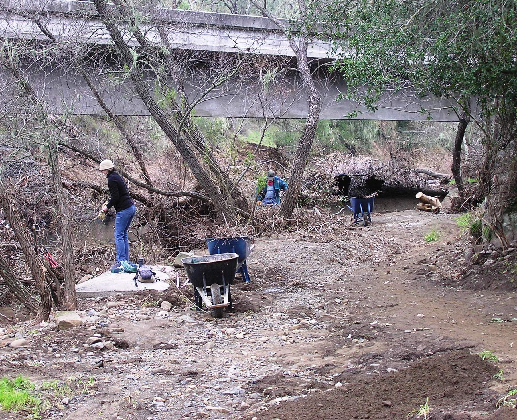 Removing debris from under the overpass.